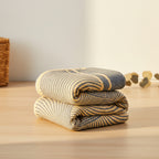 Folded blue and yellow striped towel on a white background