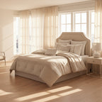 Neatly made bed with decorative pillows in a well-lit bedroom.