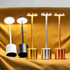 Set of five standing lamps with different metallic finishes on a textured surface.