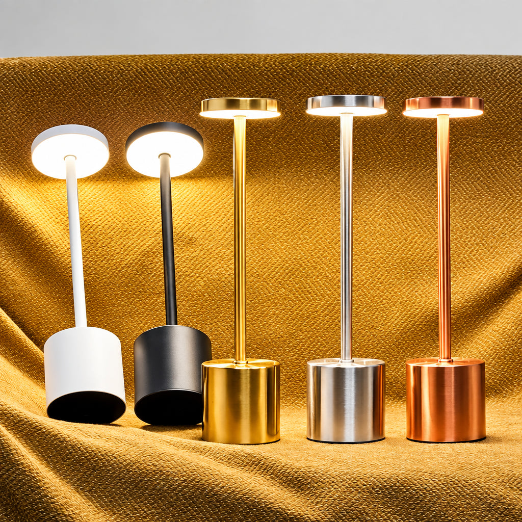 Set of five standing lamps with different metallic finishes on a textured surface.
