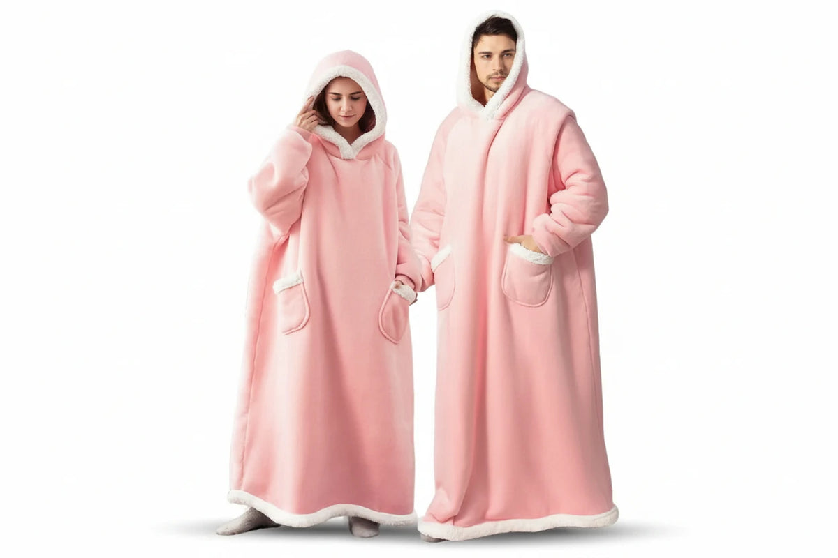 Two people wearing pink hooded blankets on a white background