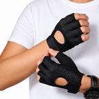 Black fingerless workout gloves with breathable mesh and wrist straps, shown being worn on a person's hands against a white shirt background.