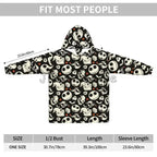 A black hooded sweatshirt with an all-over white cartoon skull-and-face print, shown on a white background with measurement arrows and a size table. The top text reads 'FIT MOST PEOPLE'.