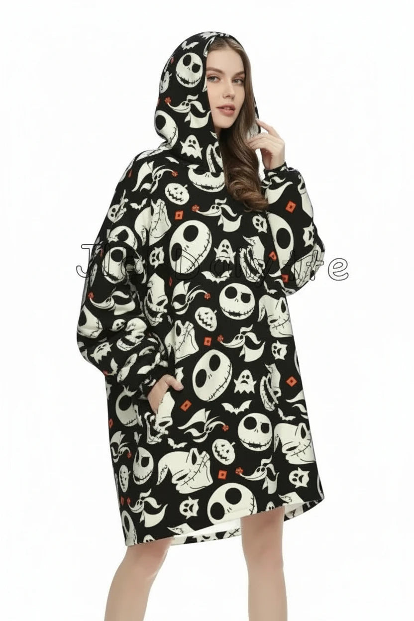 A woman wearing a hooded raincoat with a Halloween-themed print featuring Jack Skellington, ghosts, bats, and pumpkins on a black background, set against a plain white studio backdrop.
