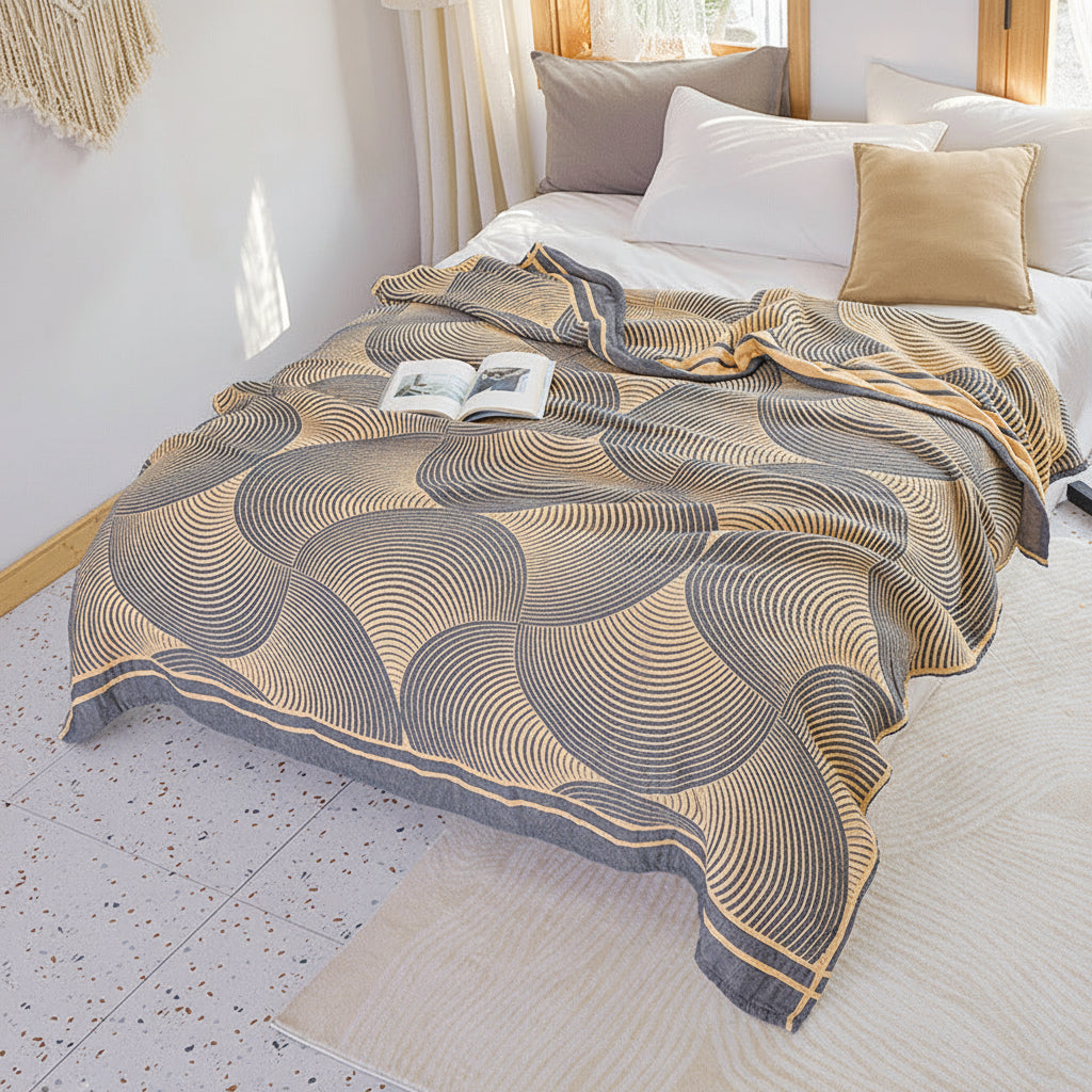 Geometric patterned throw blanket on a bed in a bright bedroom
