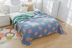 Floral patterned comforter on a bed in a bright bedroom