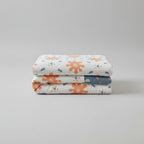 Floral patterned comforter on a bed in a bright bedroom