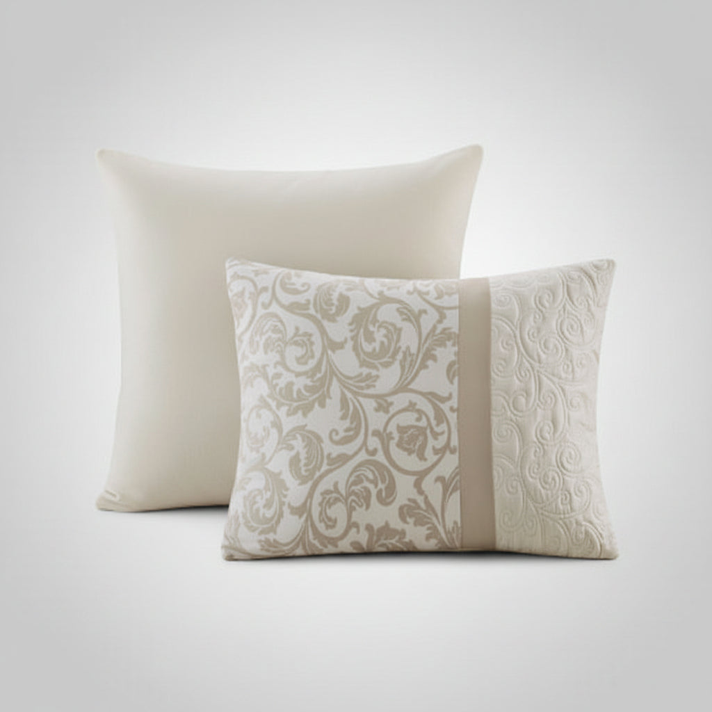 Two decorative pillows, one plain and one with a floral pattern, on a white background.